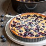 Blueberry clafoutis fresh out of the oven with golden-brown top and blueberries god